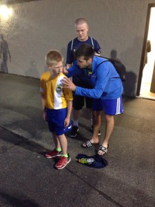 Players stayed after the game to sign an eager fan's jersey.